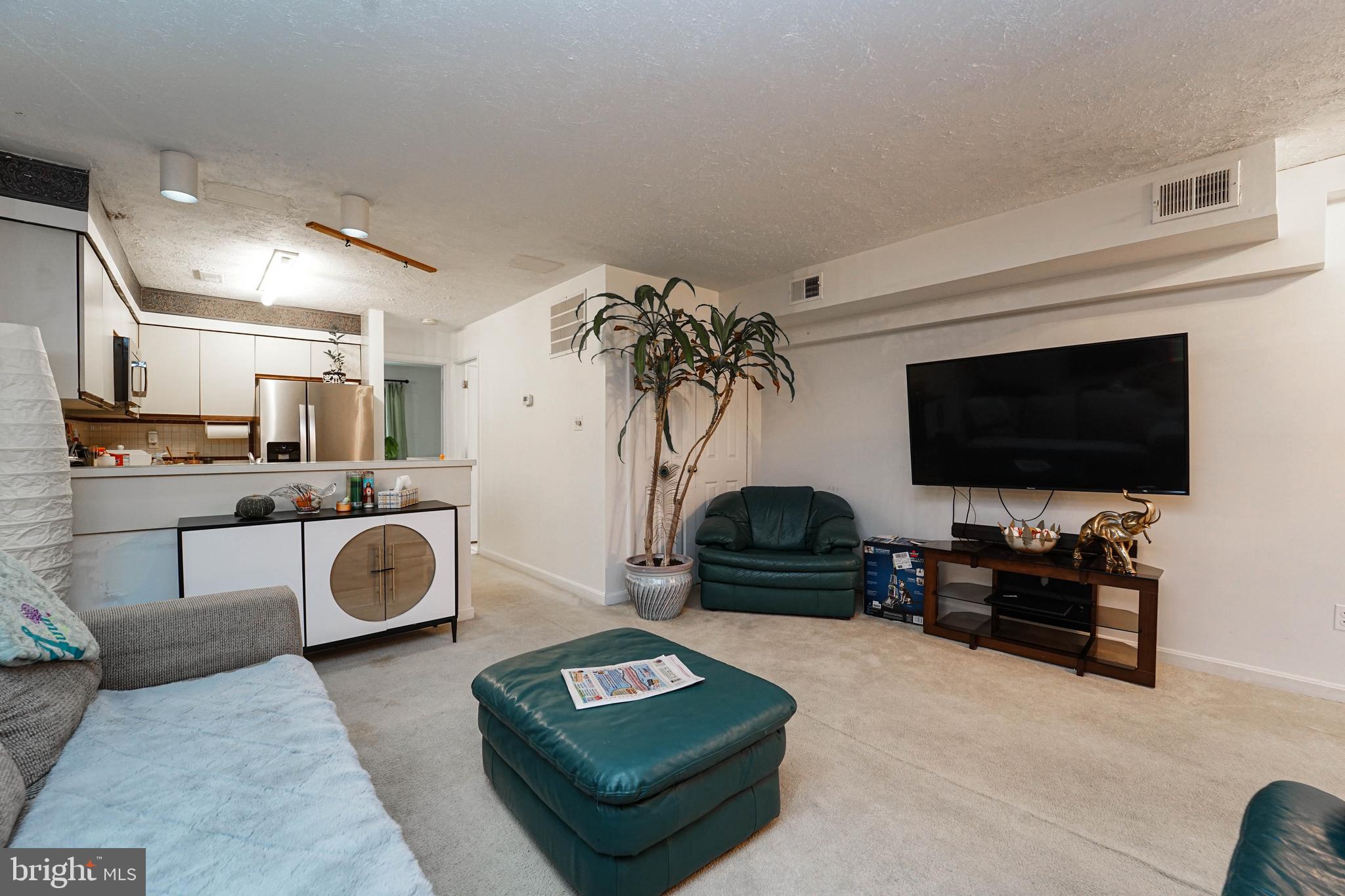 8 Queen Victoria Way Chester, MD 21619 - Photo 17 of 30 a living room with furniture and a flat screen tv