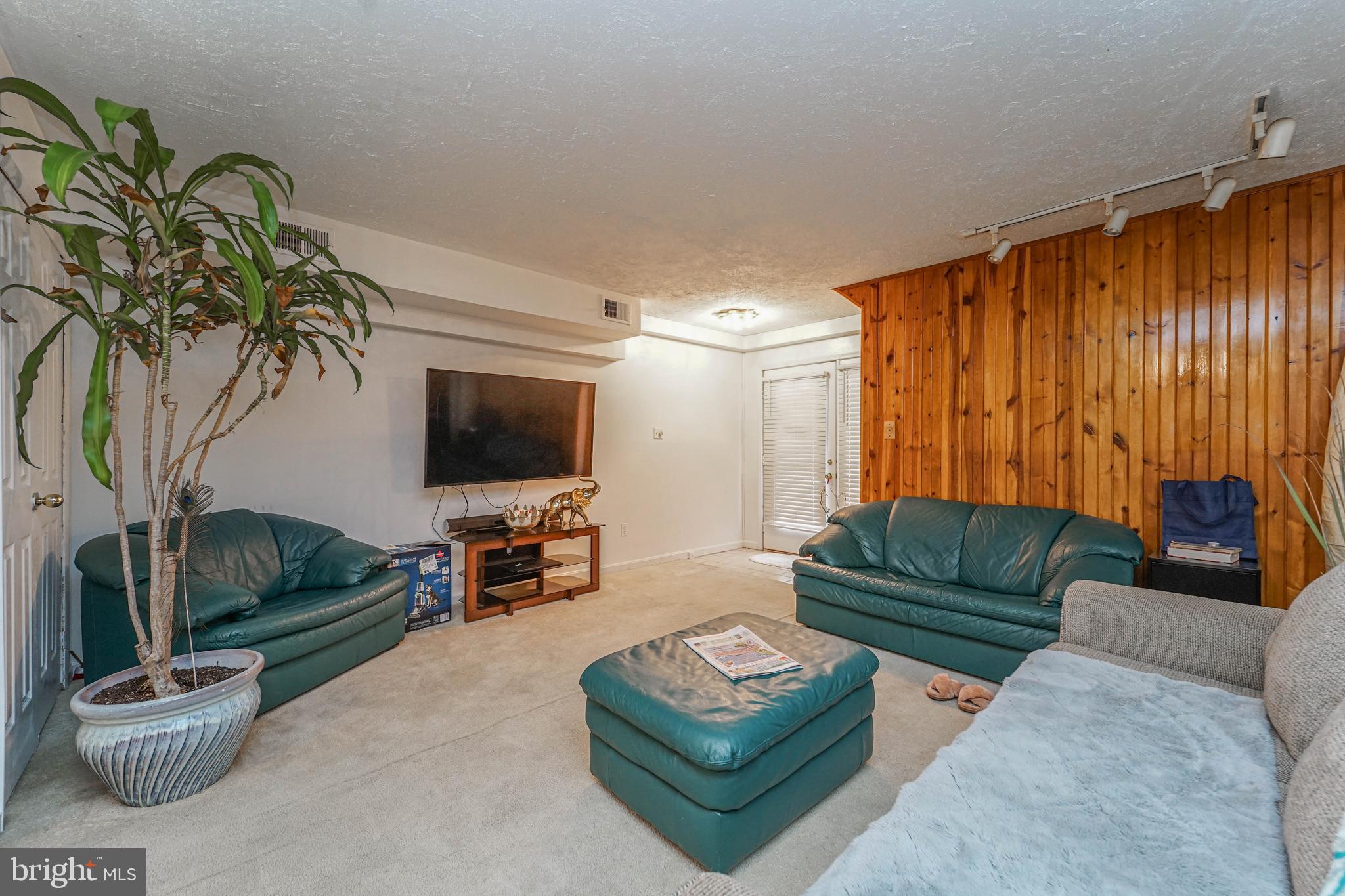 8 Queen Victoria Way Chester, MD 21619 - Photo 19 of 30 a living room with furniture and a flat screen tv