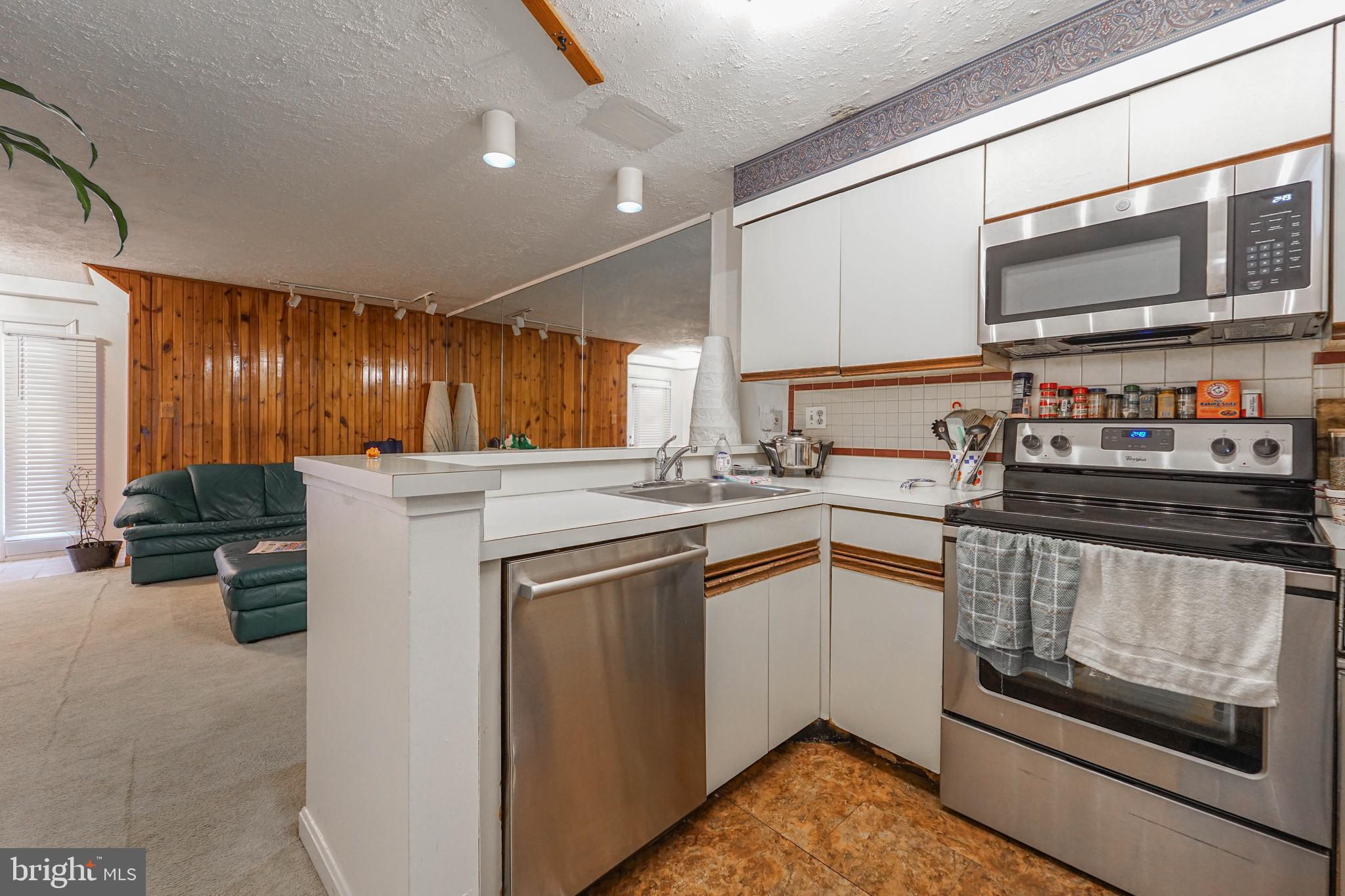 8 Queen Victoria Way Chester, MD 21619 - Photo 22 of 30 a kitchen with stainless steel appliances granite countertop a stove microwave and sink