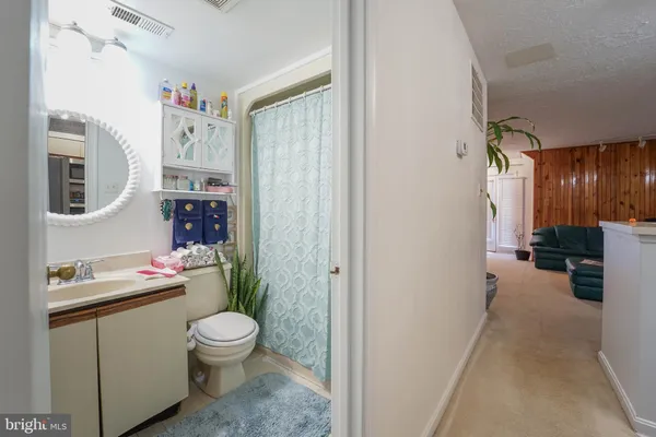 a bed sitting in a bedroom and wooden floor