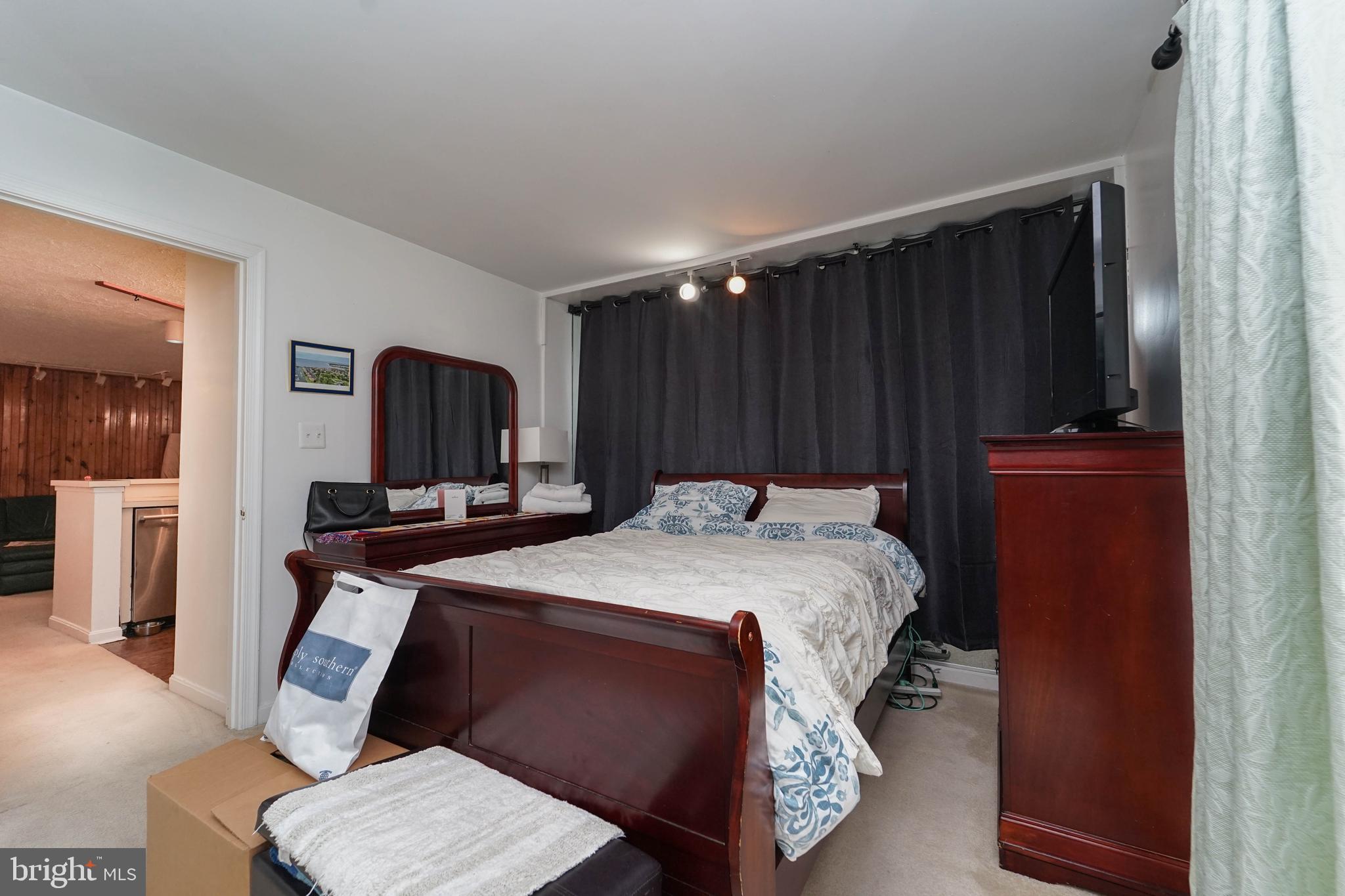 8 Queen Victoria Way Chester, MD 21619 - Photo 27 of 30 a bed sitting in a bedroom and wooden floor