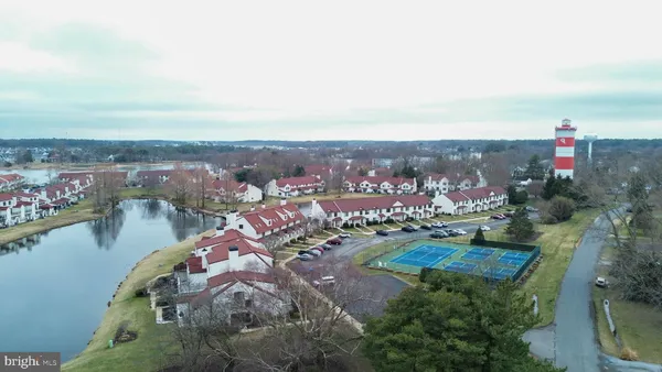 an aerial view of a house with outdoor space and lake view