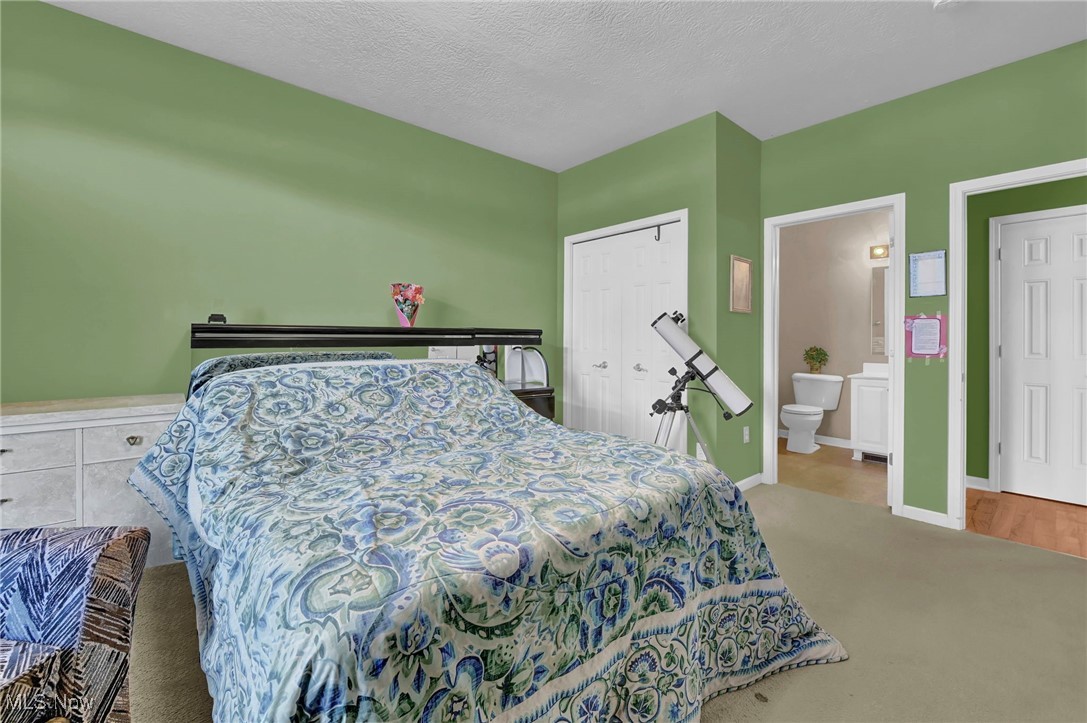 2690 Mayfair Road Akron, OH 44312 - Photo 20 of 31 Carpeted ensuite with view of bathroom, a closet.