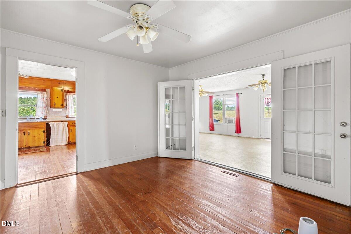109 Little Ponderosa Road Macon, NC 27551 - Photo 21 of 32 a view of an empty room with window and wooden floor