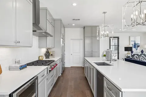 a kitchen with stainless steel appliances a sink stove and refrigerator