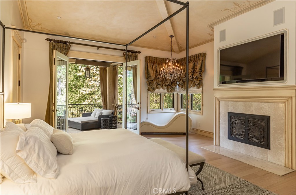 12094 Summit Circle Beverly Hills, CA 90210 - Photo 13 of 23 a bedroom with a bed and a flat screen tv