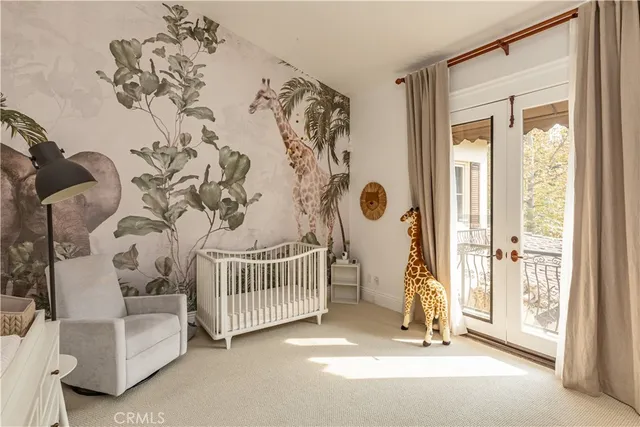 a view of a bedroom with a bed and a window