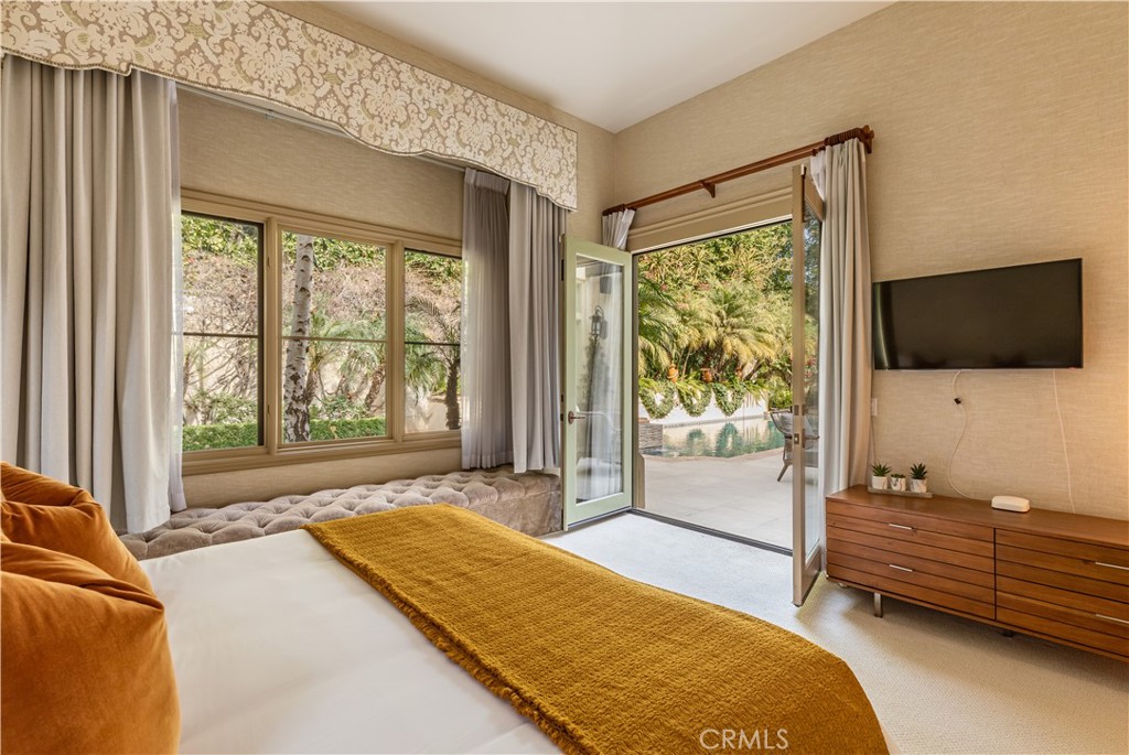 12094 Summit Circle Beverly Hills, CA 90210 - Photo 18 of 23 a bedroom with furniture and flat screen tv