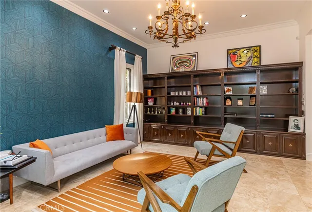 a living room with furniture a rug and a chandelier