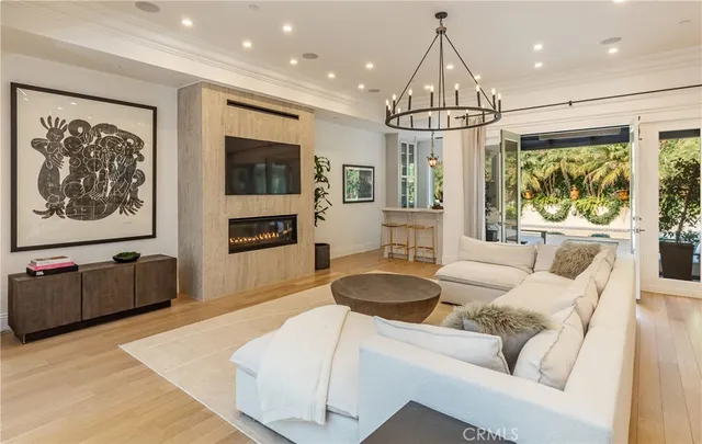 a living room with furniture a flat screen tv and a large window
