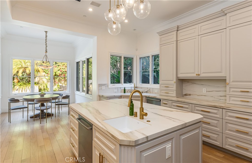 12094 Summit Circle Beverly Hills, CA 90210 - Photo 9 of 23 a kitchen with a table chairs and a chandelier