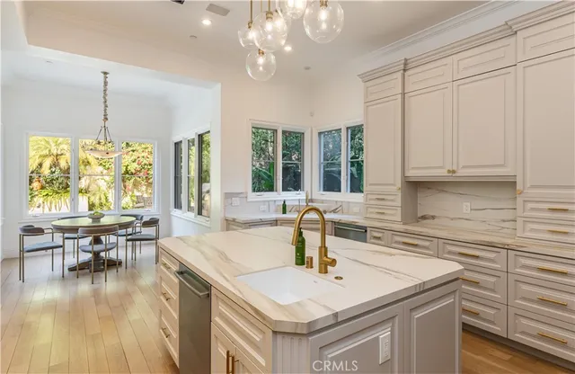 a kitchen with a table chairs and a view of living room