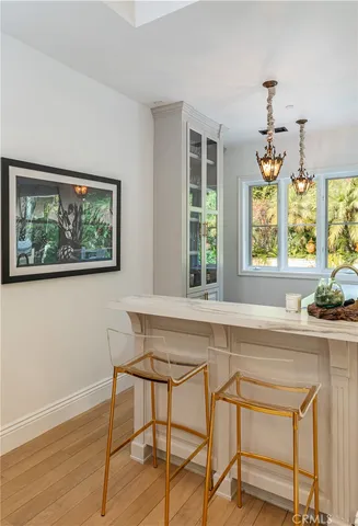 a white kitchen with a window and furniture