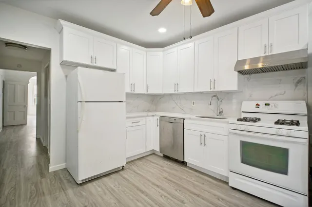 a kitchen with a white cabinets and white appliances