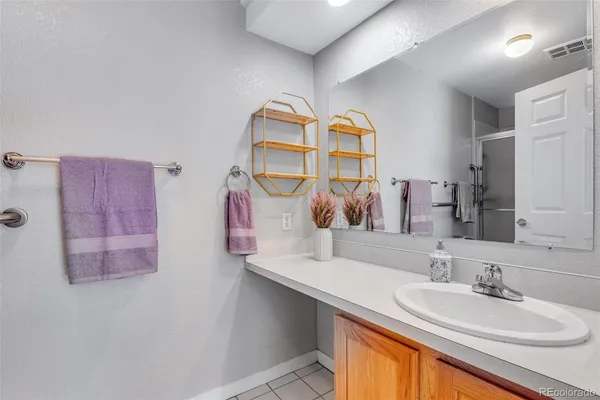 a bathroom with a sink mirror and vanity