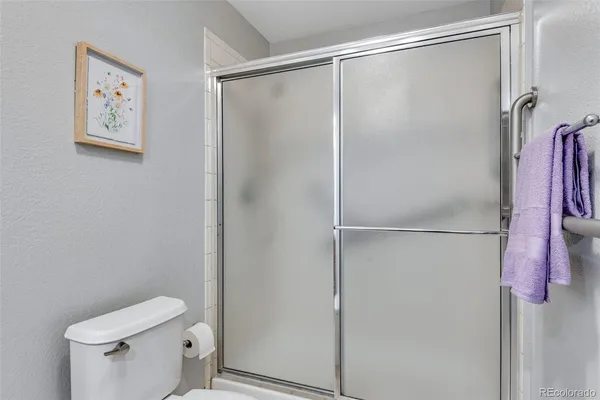 a bathroom with a shower and a toilet