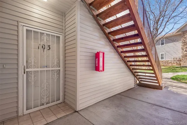 a view of a house with a door and wooden walls