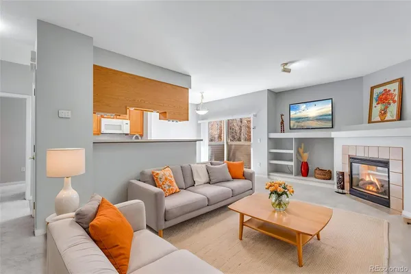 a living room with furniture and a fireplace