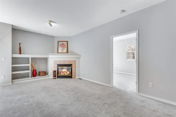 a view of a livingroom with a fireplace and window