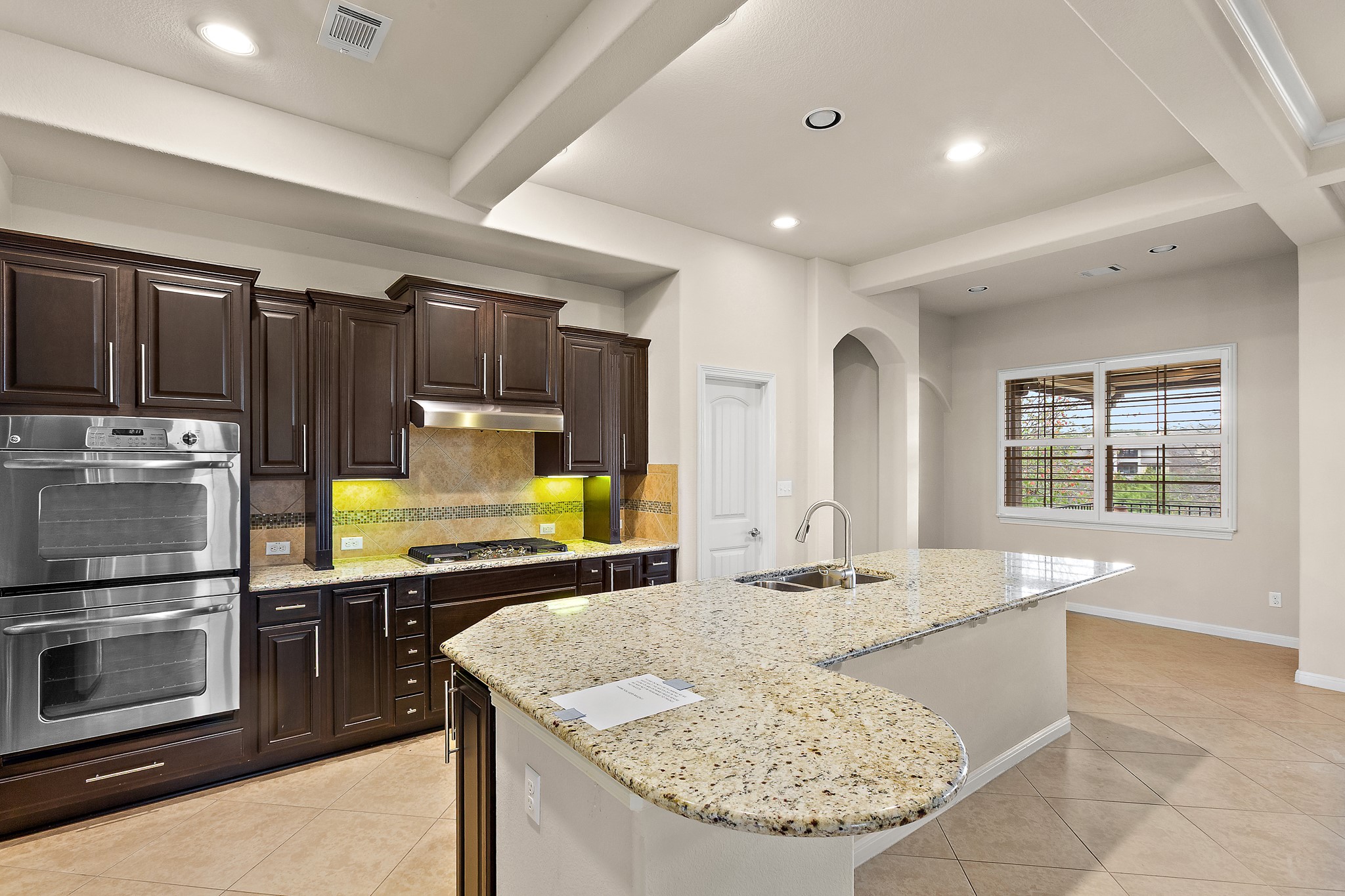 224 Tavish Trail Austin, TX 78738 - Photo 14 of 40 a kitchen with kitchen island granite countertop a stove and a sink