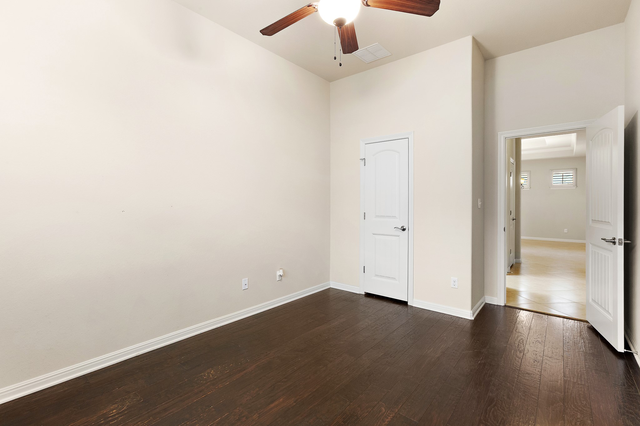 224 Tavish Trail Austin, TX 78738 - Photo 23 of 40 an empty room with wooden floor cabinet and a ceiling fan