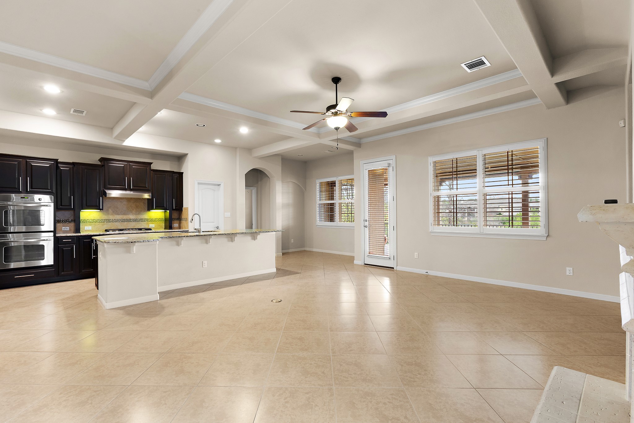224 Tavish Trail Austin, TX 78738 - Photo 8 of 40 a view of an empty room with kitchen view and a window