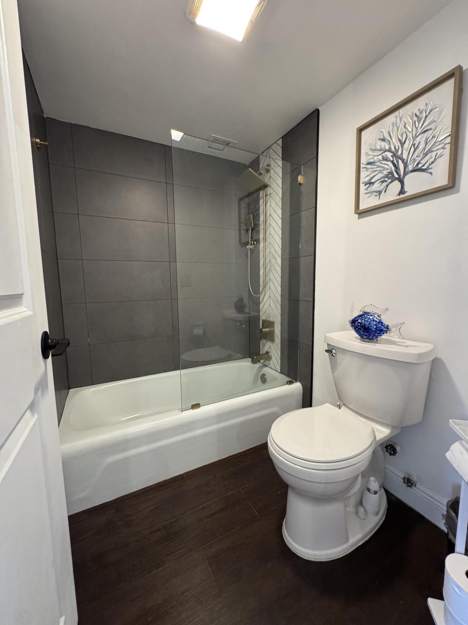 6 Royal Palm Way, Unit 202 Boca Raton, FL 33432 - Photo 9 of 29 a bathroom with a toilet and a bathtub