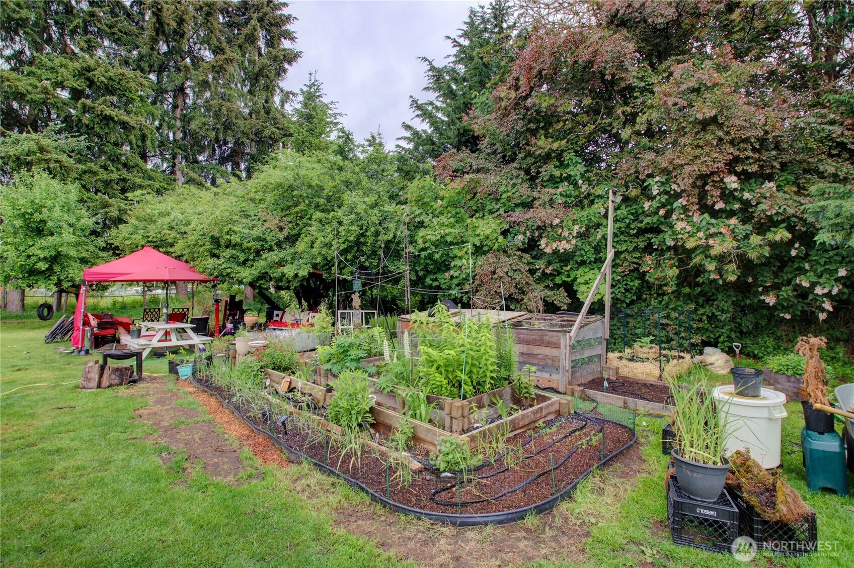 7185 Old Highway 99 North Road Burlington, WA 98233 - Photo 15 of 26 a view of a table and chairs under an umbrella in a yard