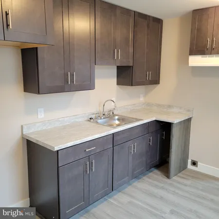 a kitchen with stainless steel appliances granite countertop wooden cabinets a sink and dishwasher