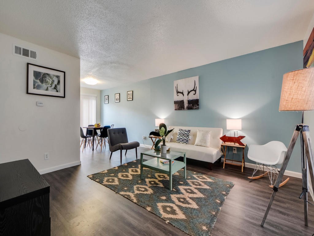 5005 Manor Road, Unit 129 Austin, TX 78723 - Photo 1 of 1 a living room with furniture and wooden floor