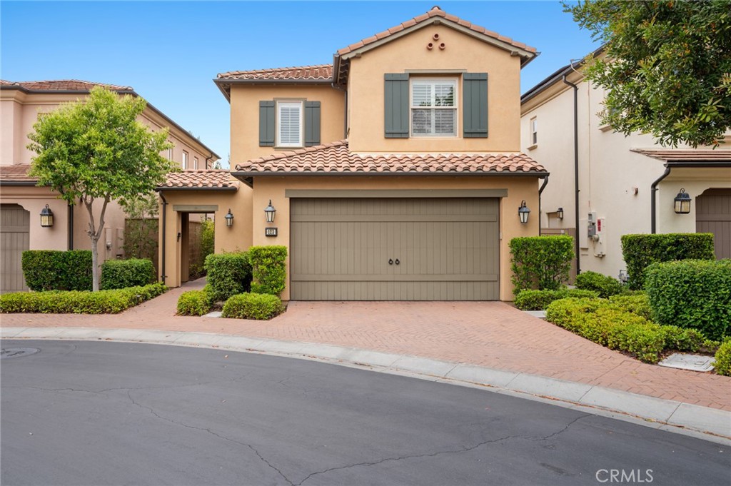 123 Windham Irvine, CA 92620 - Photo 1 of 1 a front view of a house with a yard and garage