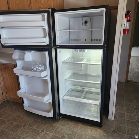 3760 Gold Ridge Drive, Unit 82 Magna, UT 84044 - Photo 14 of 29 Stainless steel top-freezer refrigerator with clear crisper drawers, adjustable shelving, and door storage