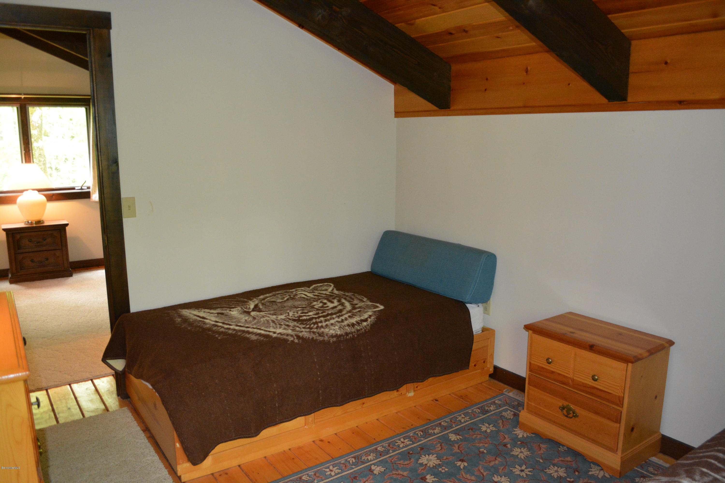 56 Slope Road Tolland, MA 01034 - Photo 16 of 52 a bedroom with a bed and wooden floor