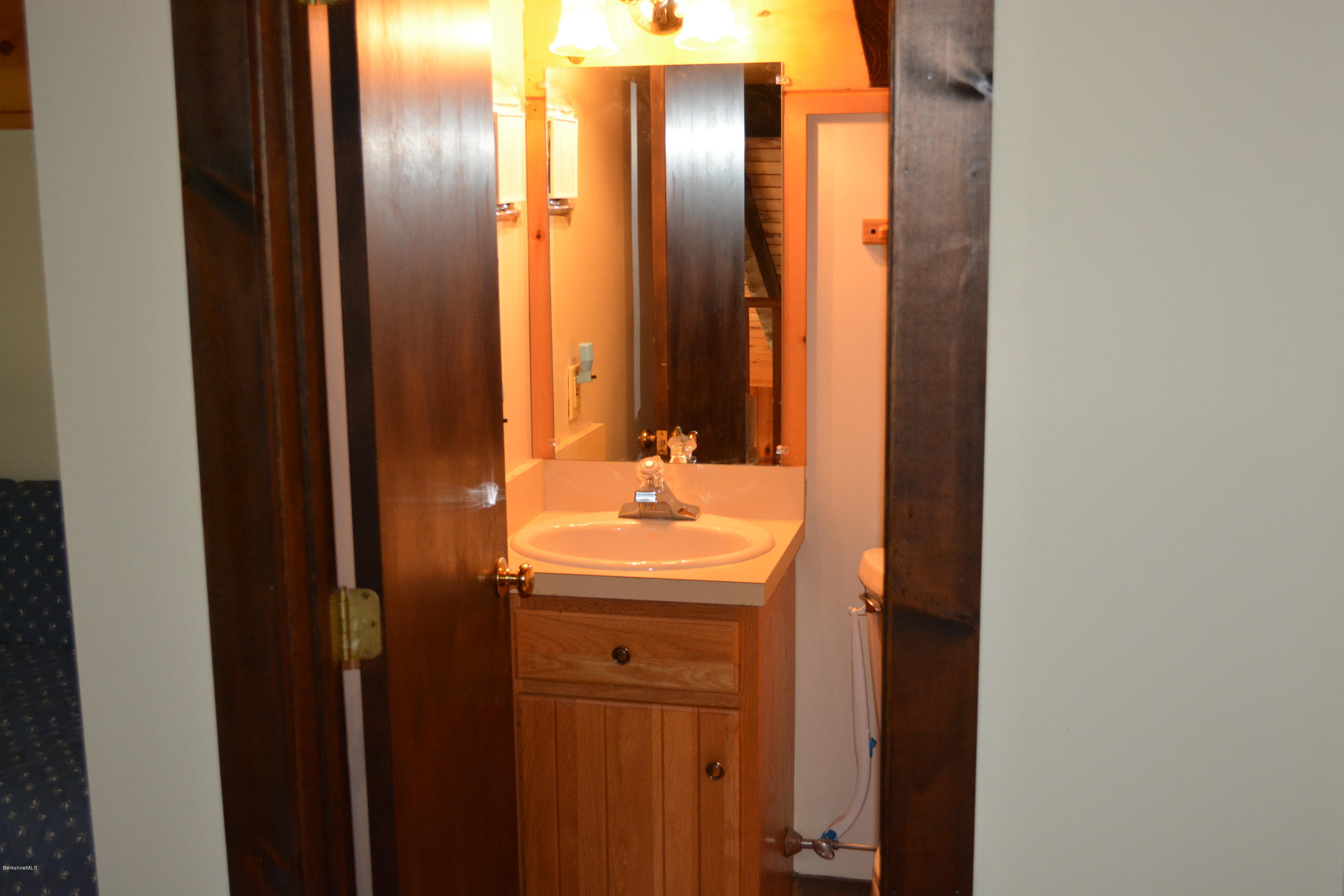 56 Slope Road Tolland, MA 01034 - Photo 18 of 52 a bathroom with a sink and a mirror