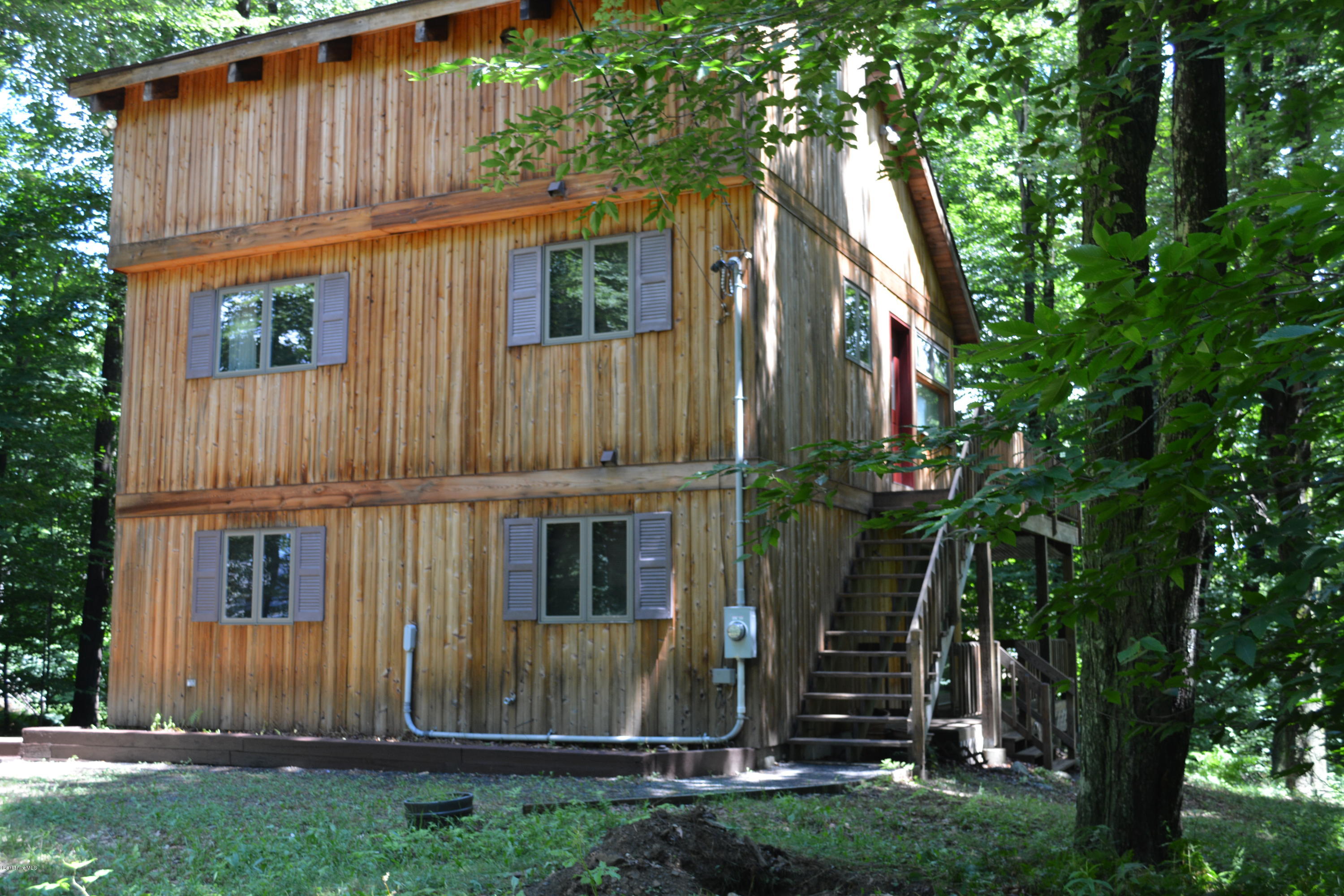 56 Slope Road Tolland, MA 01034 - Photo 25 of 52 a view of a house with backyard and plants