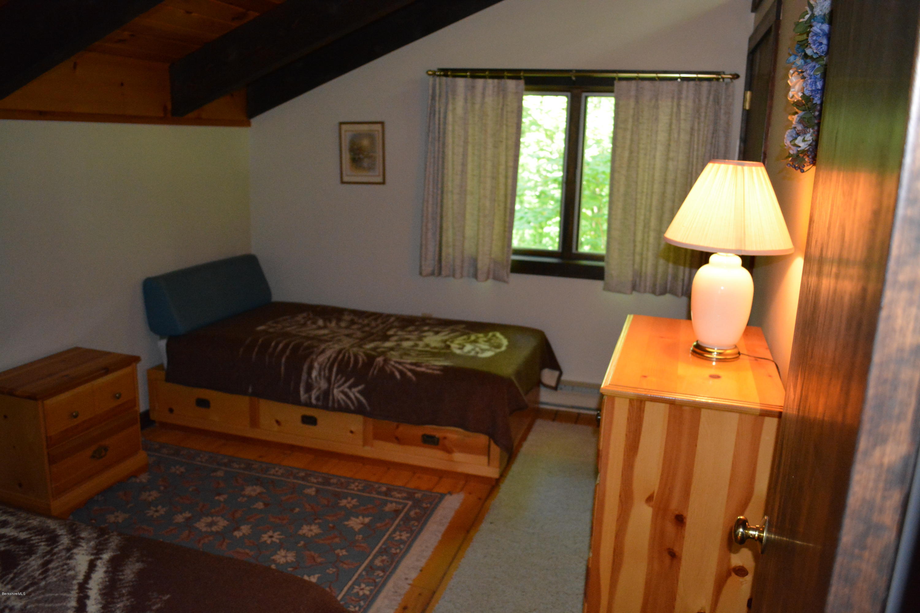 56 Slope Road Tolland, MA 01034 - Photo 27 of 52 a bedroom with a bed and a window