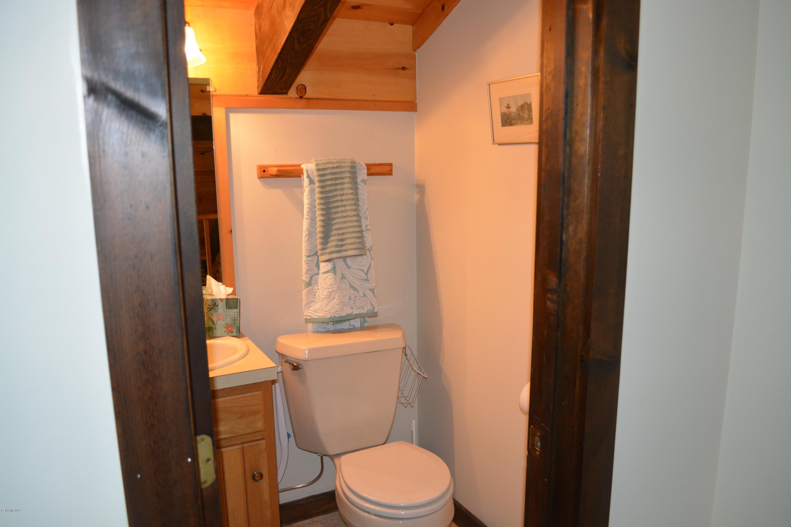 56 Slope Road Tolland, MA 01034 - Photo 48 of 52 a white toilet sitting next to a bathroom sink