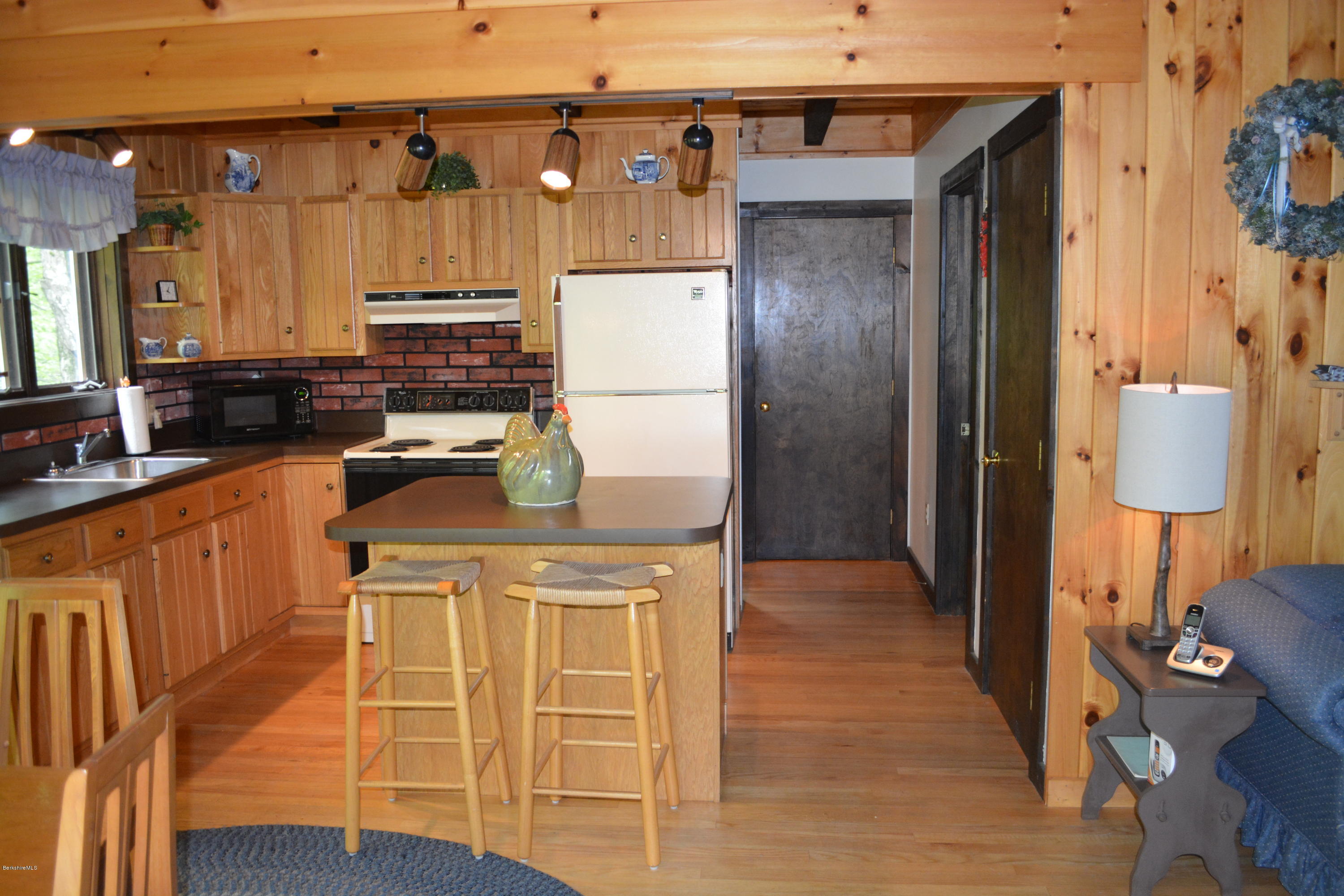56 Slope Road Tolland, MA 01034 - Photo 6 of 52 a kitchen with a refrigerator and a stove top oven