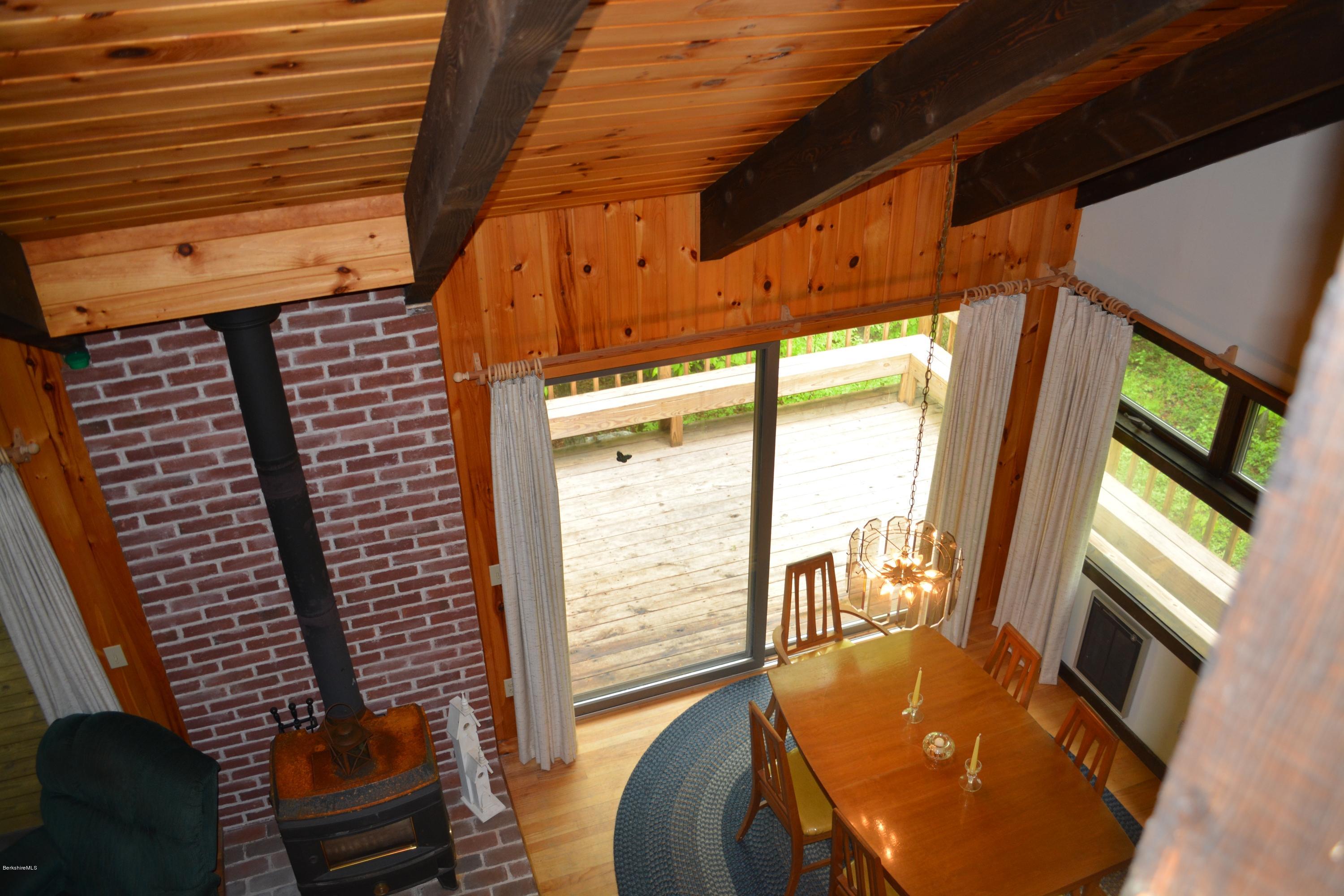 56 Slope Road Tolland, MA 01034 - Photo 51 of 52 a view of a balcony with floor to ceiling windows with wooden floor