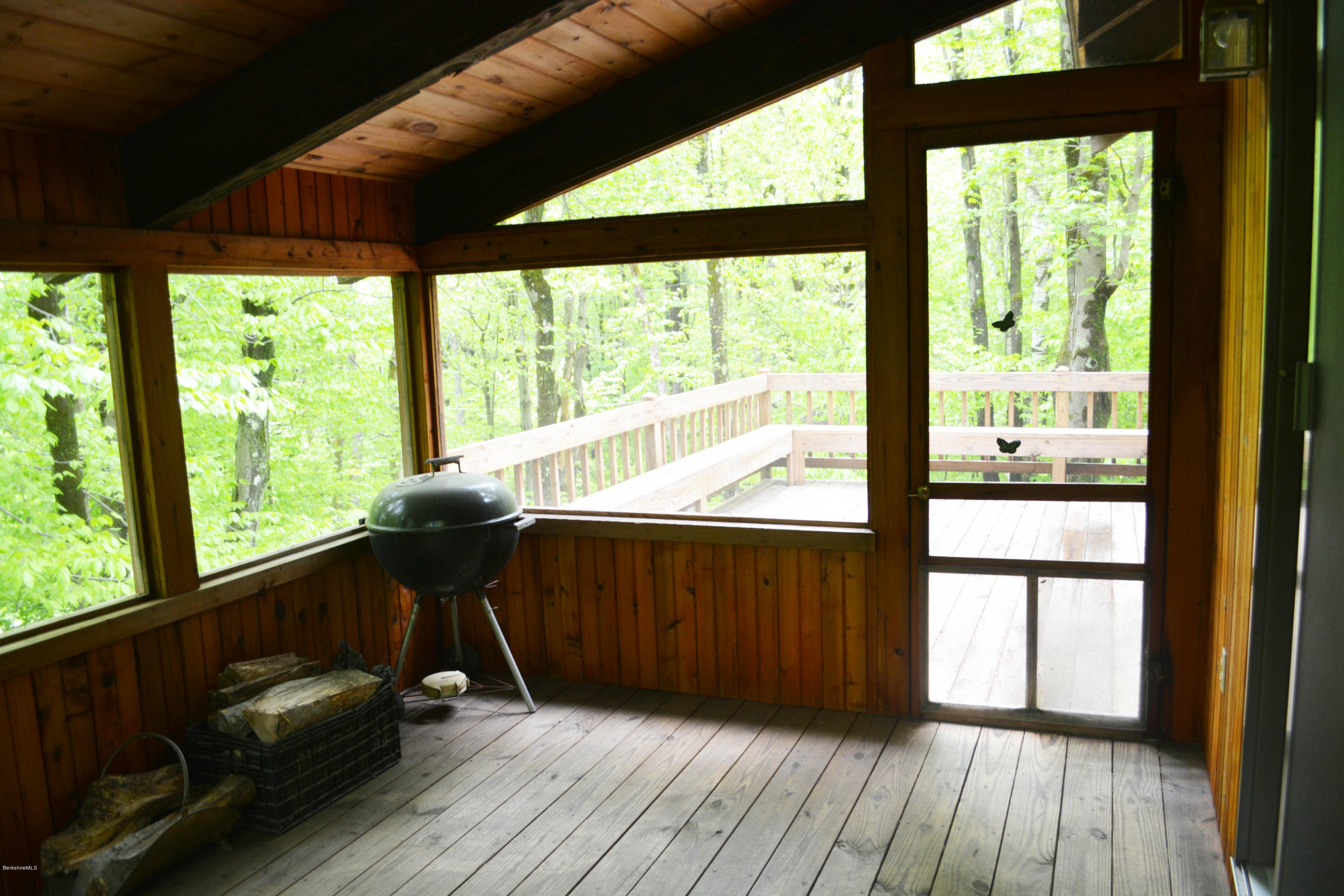 56 Slope Road Tolland, MA 01034 - Photo 8 of 52 a view of a balcony with chair and wooden floor