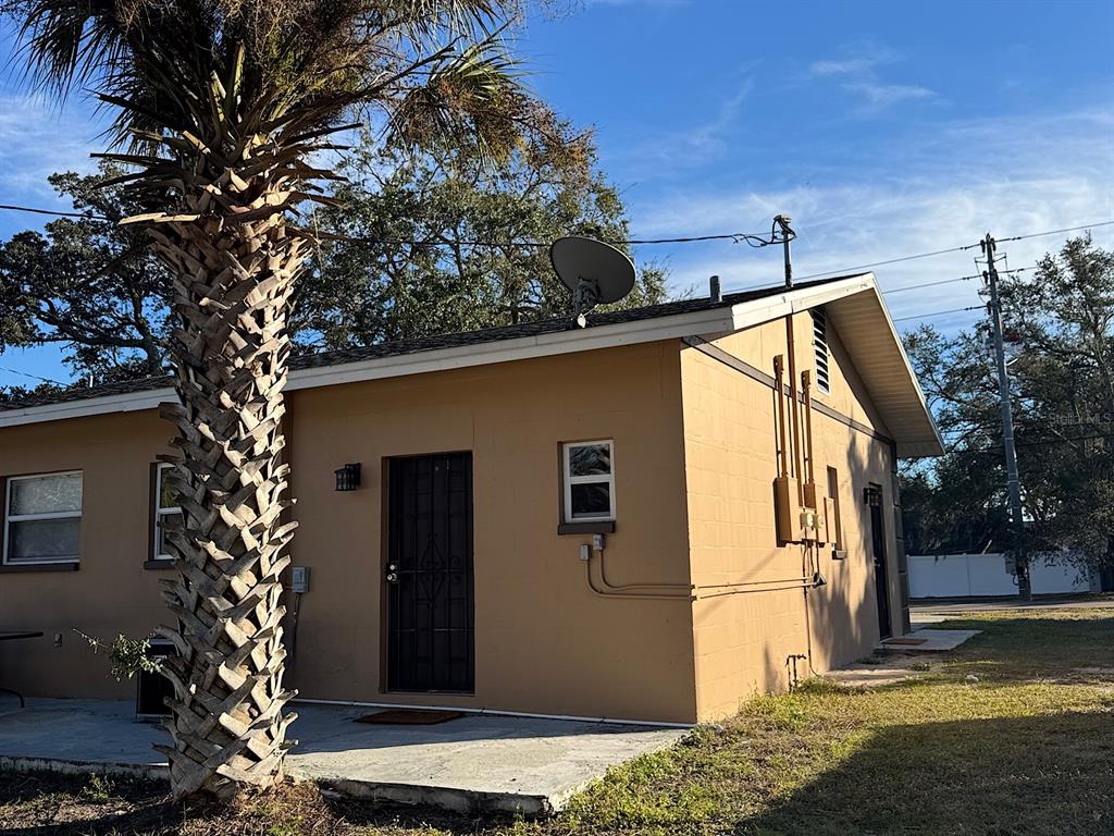 623 Beckett Way, Unit A Tarpon Springs, FL 34689 - Photo 17 of 19 a view of a house with a yard