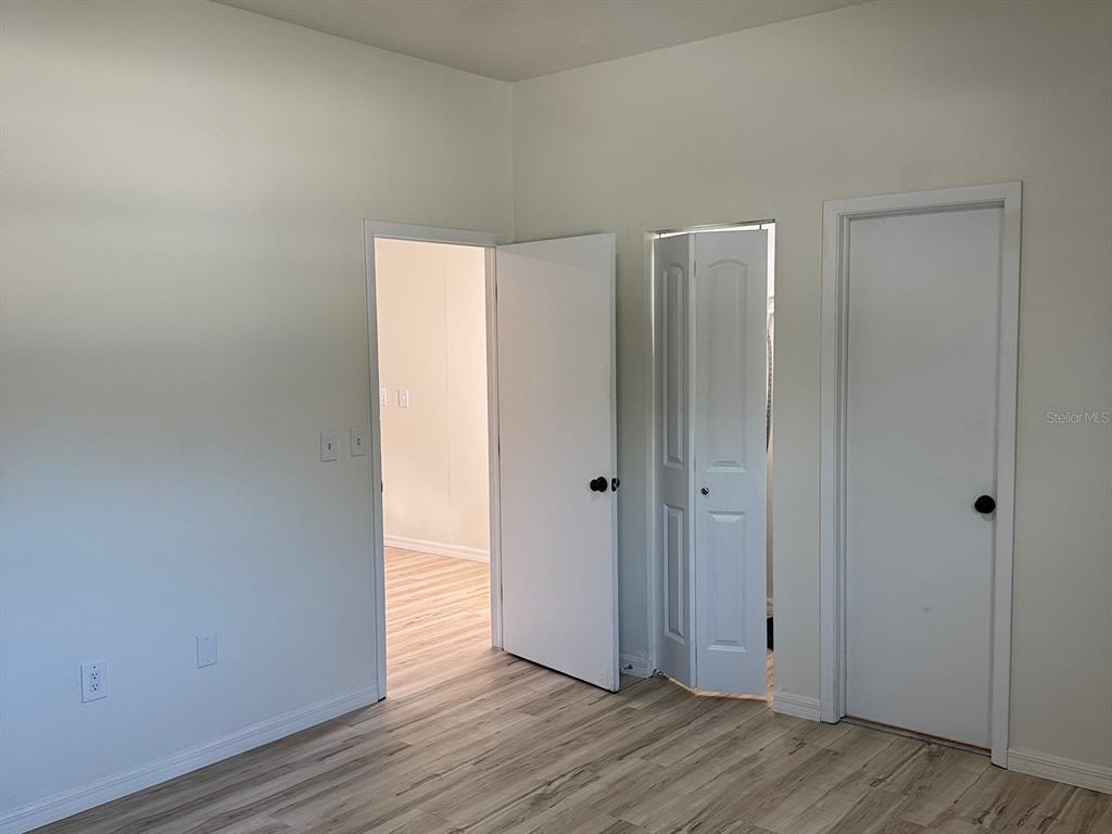 623 Beckett Way, Unit A Tarpon Springs, FL 34689 - Photo 8 of 19 a view of an empty room with wooden floor