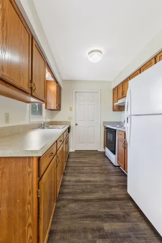 a kitchen with stainless steel appliances granite countertop a sink stove and refrigerator
