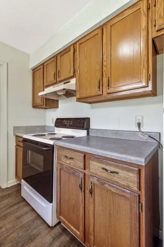 a kitchen with stainless steel appliances granite countertop a sink and a stove