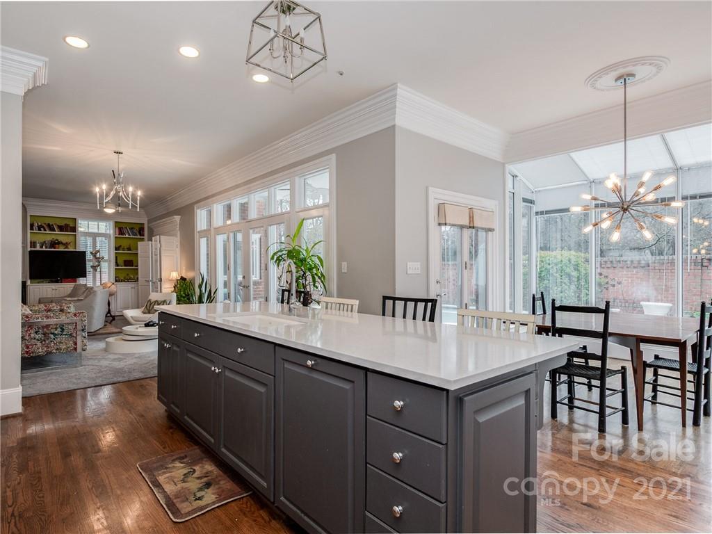 2131 Rolston Drive Charlotte, NC 28207 - Photo 12 of 35 a kitchen with stainless steel appliances a dining table chairs and couches