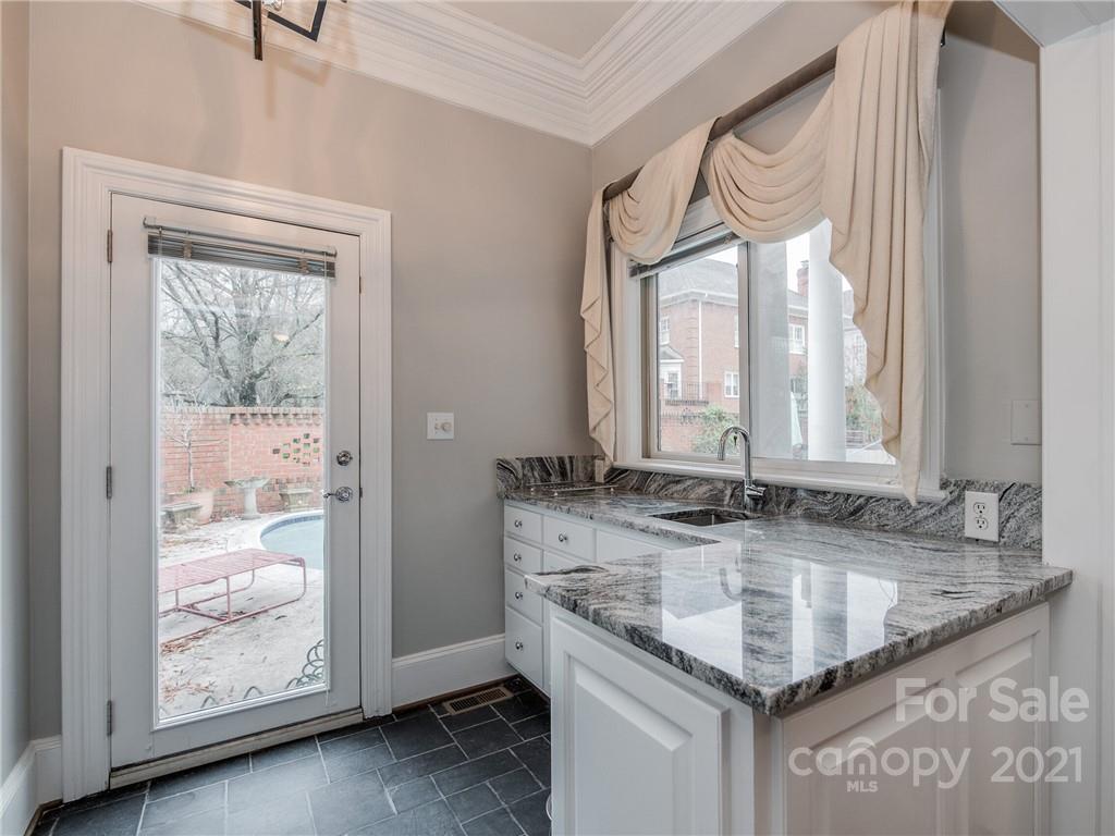 2131 Rolston Drive Charlotte, NC 28207 - Photo 14 of 35 a bathroom with granite countertop a sink and a window