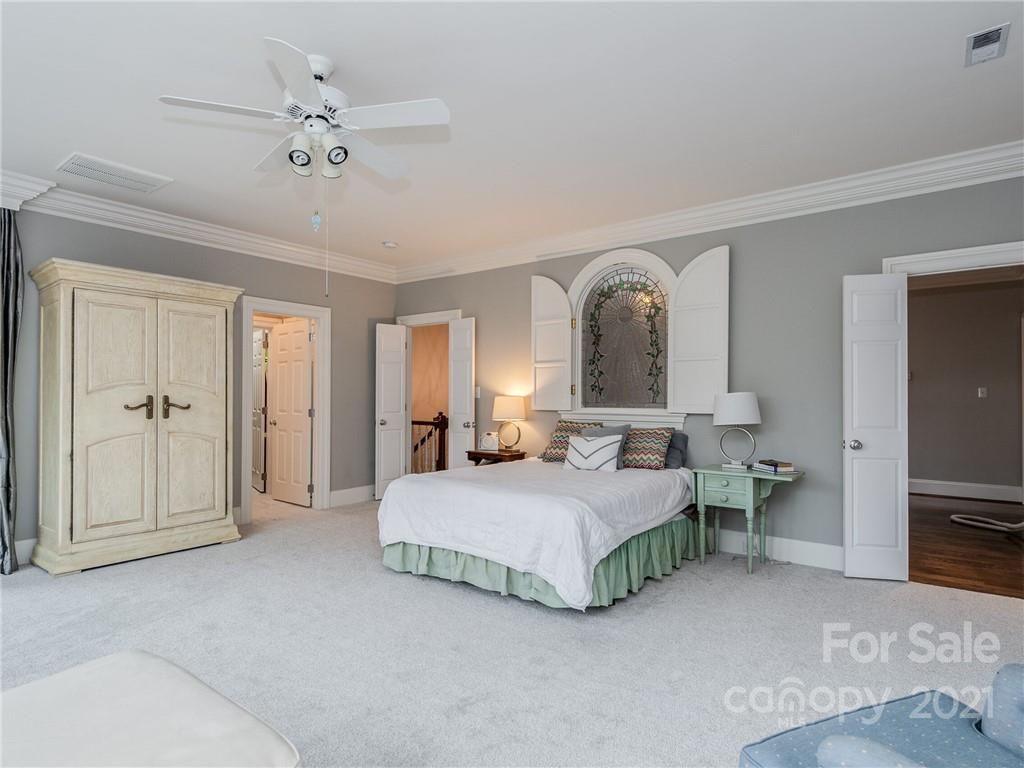 2131 Rolston Drive Charlotte, NC 28207 - Photo 21 of 35 a bedroom with a bed and a chandelier