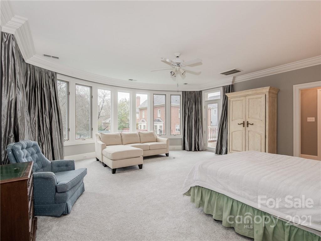 2131 Rolston Drive Charlotte, NC 28207 - Photo 22 of 35 a spacious bedroom with a bed and glass window