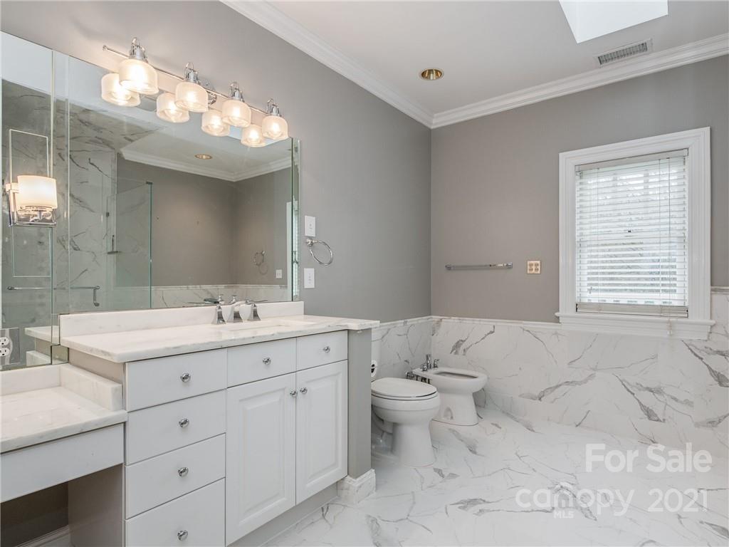 2131 Rolston Drive Charlotte, NC 28207 - Photo 23 of 35 a bathroom with a toilet a sink a large mirror and vanity