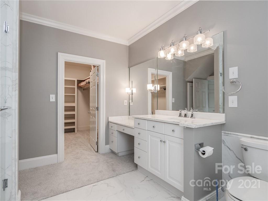2131 Rolston Drive Charlotte, NC 28207 - Photo 25 of 35 a spacious bathroom with a double vanity sink toilet and a mirror